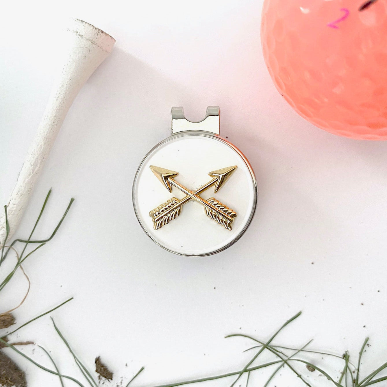 Round white object with gold arrows on a light background