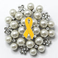 Brooch with yellow ribbon and pearls on a white background